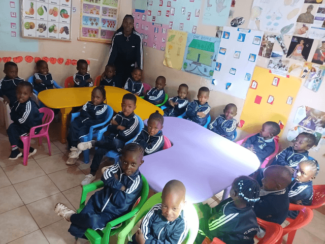 St. Scholastica learners and their teacher in the classroom